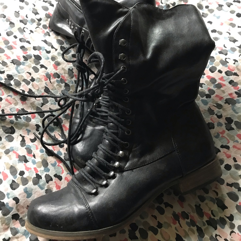 Black ankle lace up boots in a faux leather.